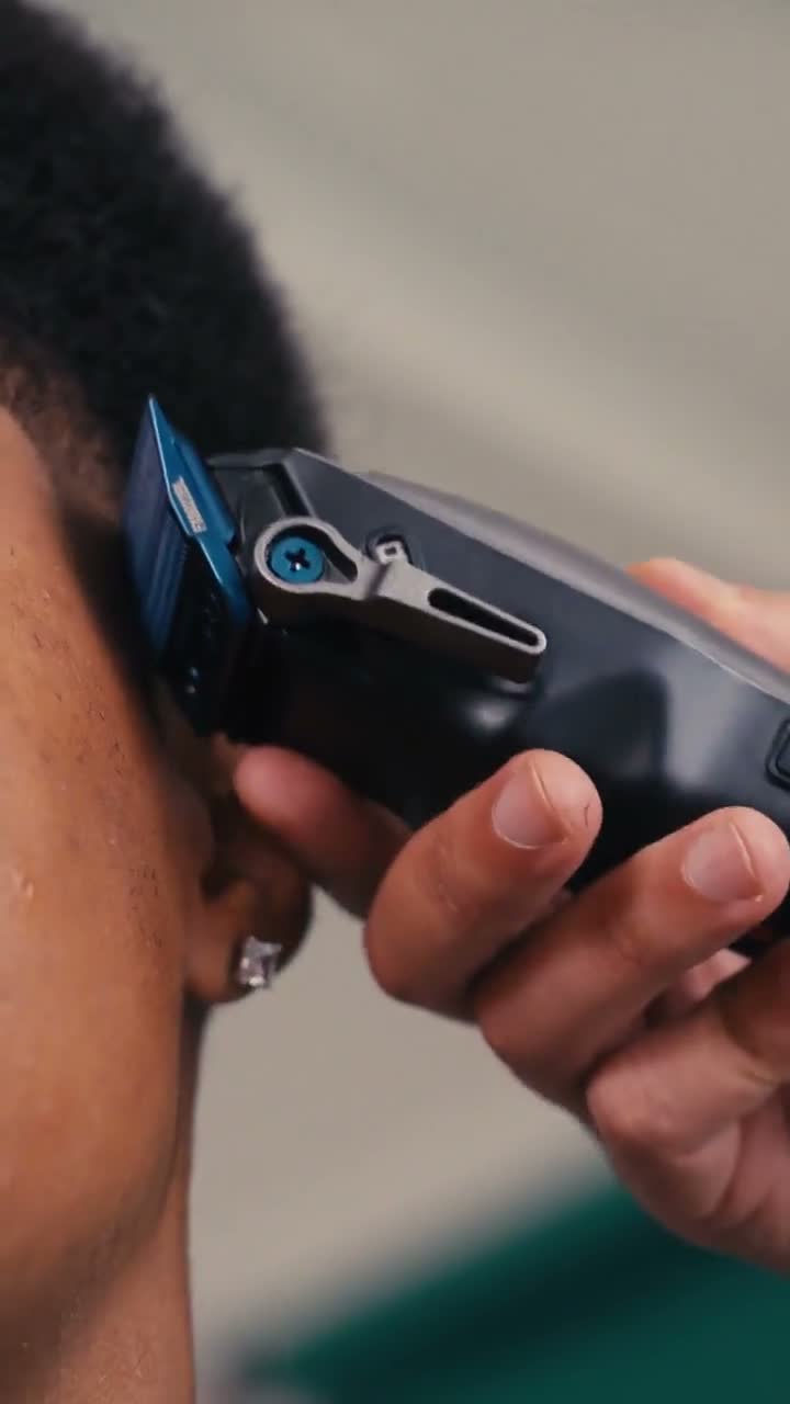 A close-up of a BaByliss clipper in use in the Tariq Howes studio film.