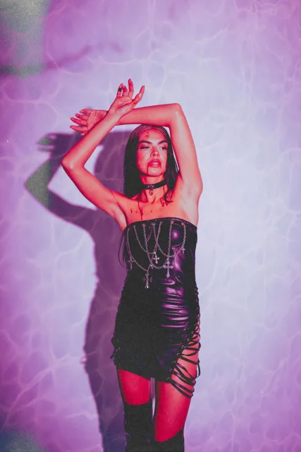 A fashion portrait lit in pink and red.