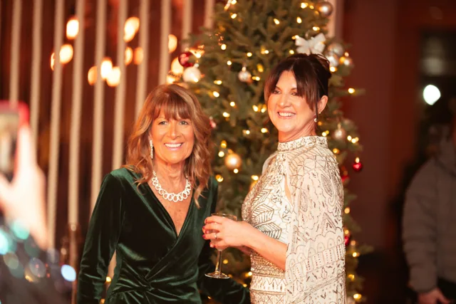 Two guests sharing a moment at a black-tie event.