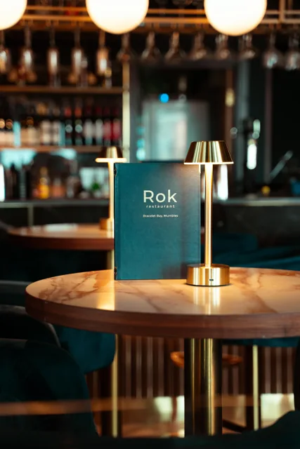 A Rok menu in warm, atmospheric bar lighting.